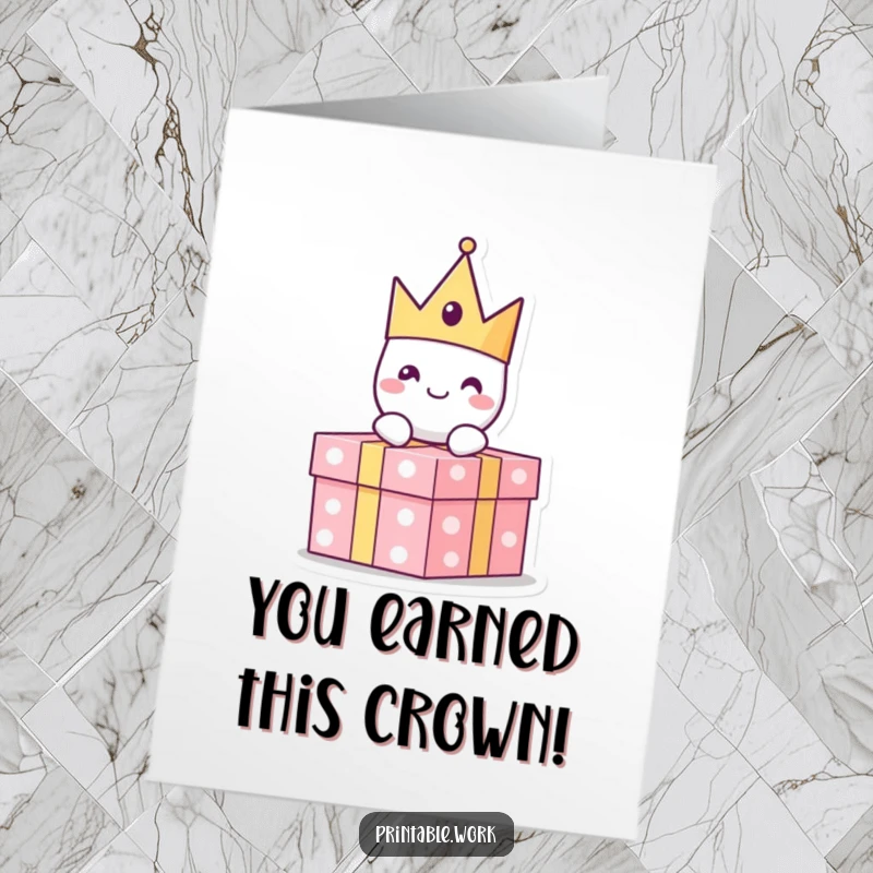 Funny Free Printable Congratulations Card: A cheerful paper crown character sits on a gift, celebrating a success.